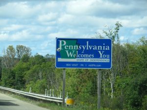 photo shows the pennsylvania state sign on the side of the highway